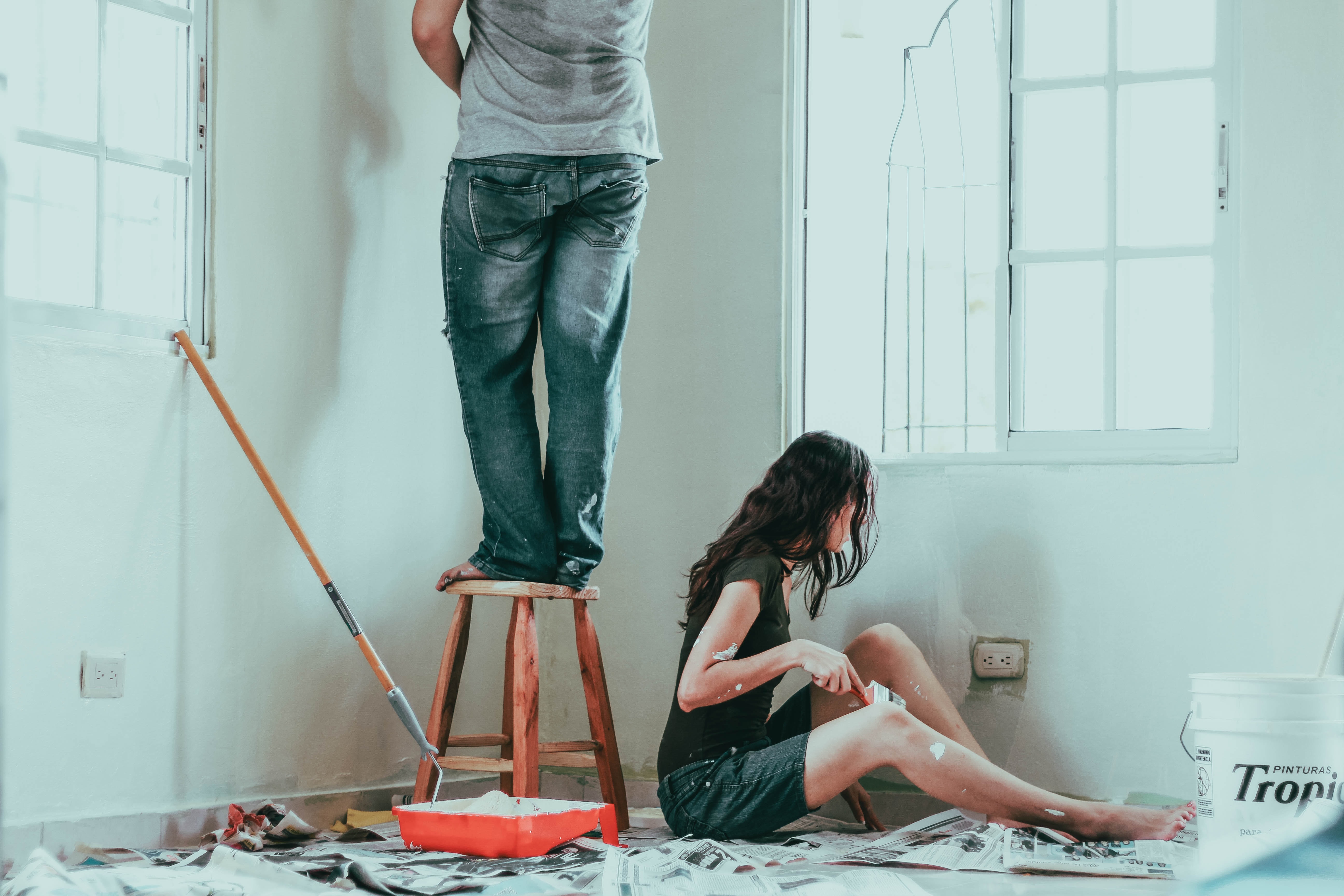 Top 10 Home Fixer Upper Trends In 2021. A couple painting a room together.